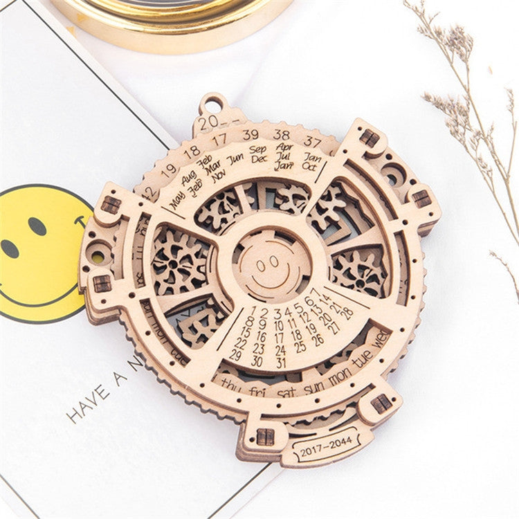 Wooden perpetual calendar gear puzzle, circular face with engraved months and numbers