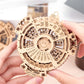 Wooden perpetual calendar gear puzzle held in hands, assembled circular mechanism