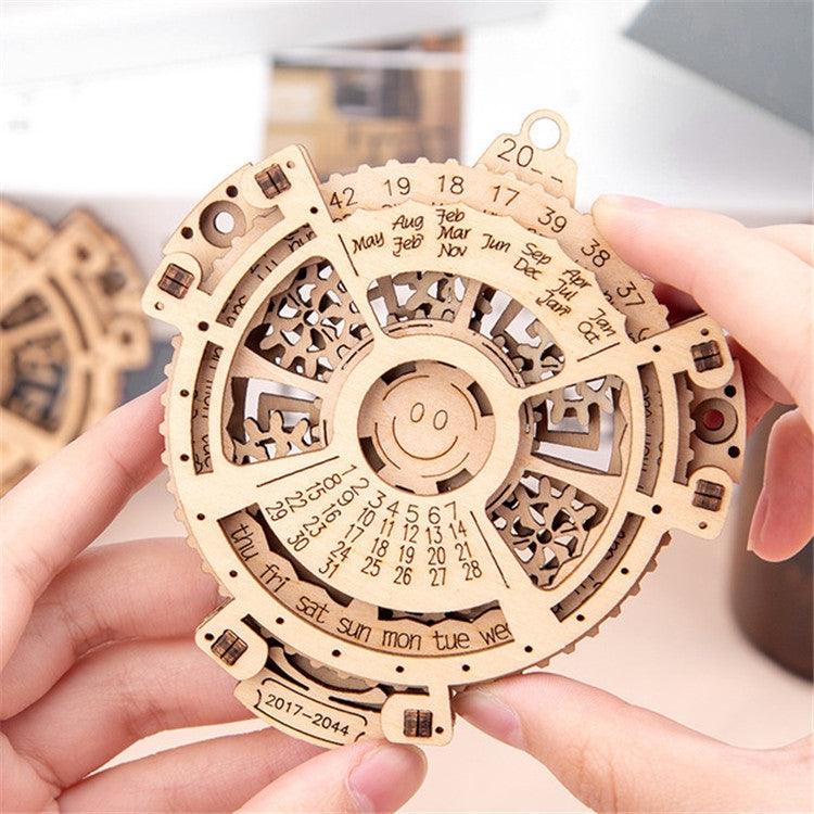 Wooden perpetual calendar gear puzzle held in hands, assembled circular mechanism