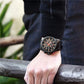 Men’s chronograph wristwatch with black case, dark dial, and black leather strap