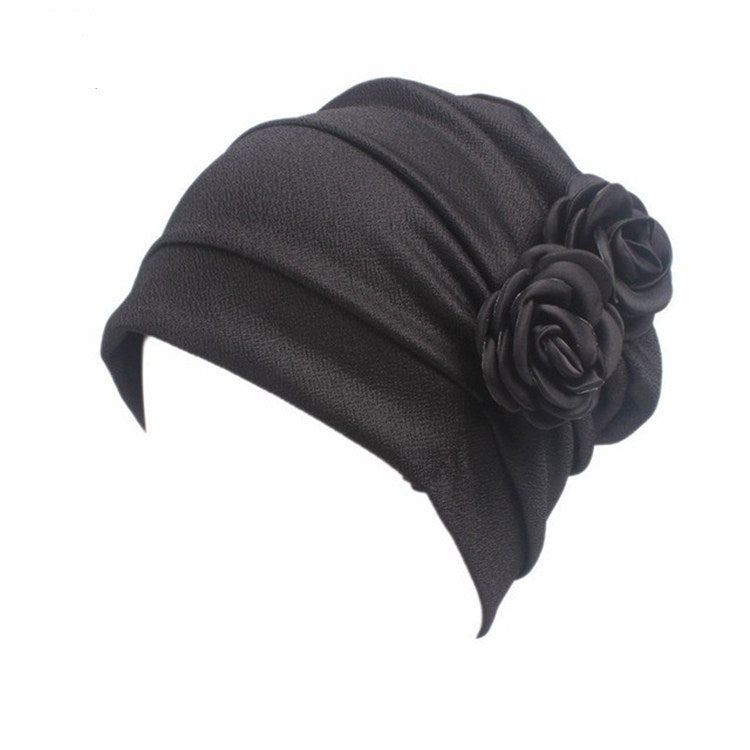 Dark gray chemo cap with pleated crown and large fabric rosette flower