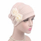 Blush pink chemo cap with pleated crown and two fabric rose flowers on side