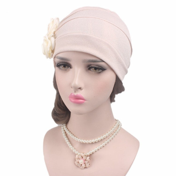 Light pink chemo cap with side fabric rose detail and smooth draped crown