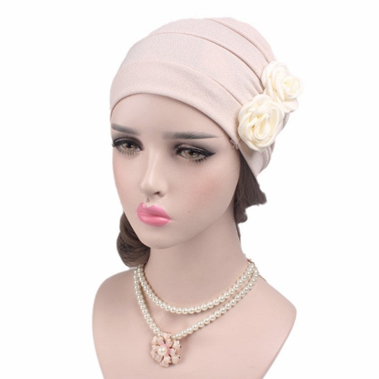 Light pink chemo cap with side fabric rose flower and pearl necklace accessory