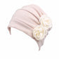 Blush pink flower knit pull-over cap with pleated headband and rosette accents