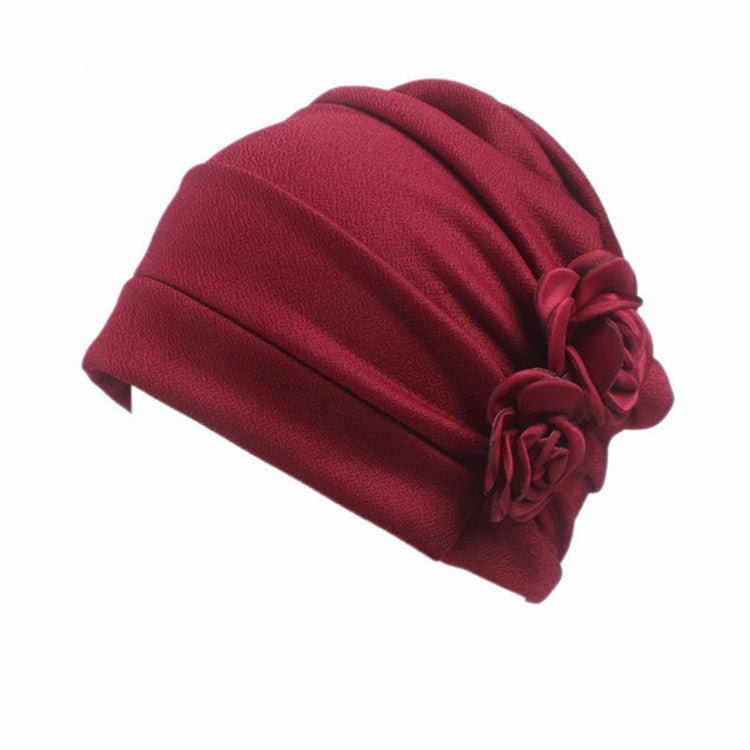 Wine red flower knit pull-over cap with pleated headband and rosette flower detail