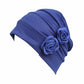 Royal blue flower knit pull-over cap with pleated headband and rosette flower accents