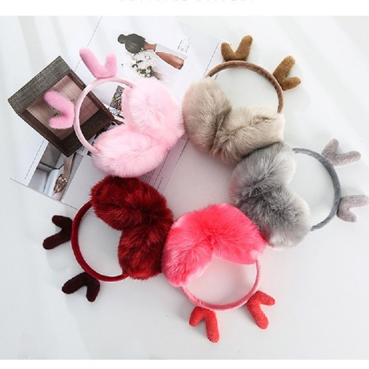 Assorted plush antler earmuffs in pink, red, gray, and dark colors on a flat lay