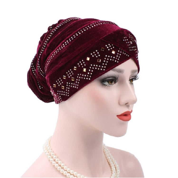 Red wine pleuche turban hat with rhinestone trim and square pattern across front, profile
