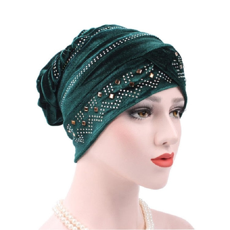 Dark green pleuche turban hat with rhinestone trim and dotted square pattern across front