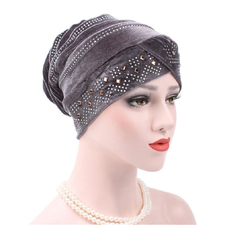 Gray pleuche turban hat with rhinestone trim and square pattern across front