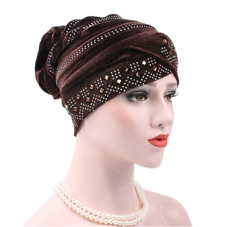 Dark brown pleuche turban hat with rhinestone trim and dotted square pattern across front