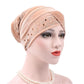 Apricot pleuche turban hat with rhinestone trim and dotted square pattern across front