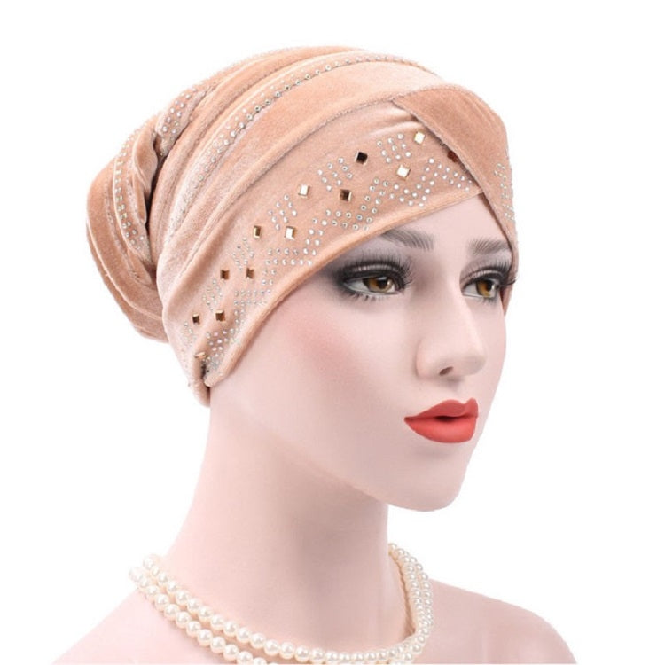 Apricot pleuche turban hat with rhinestone trim and dotted square pattern across front