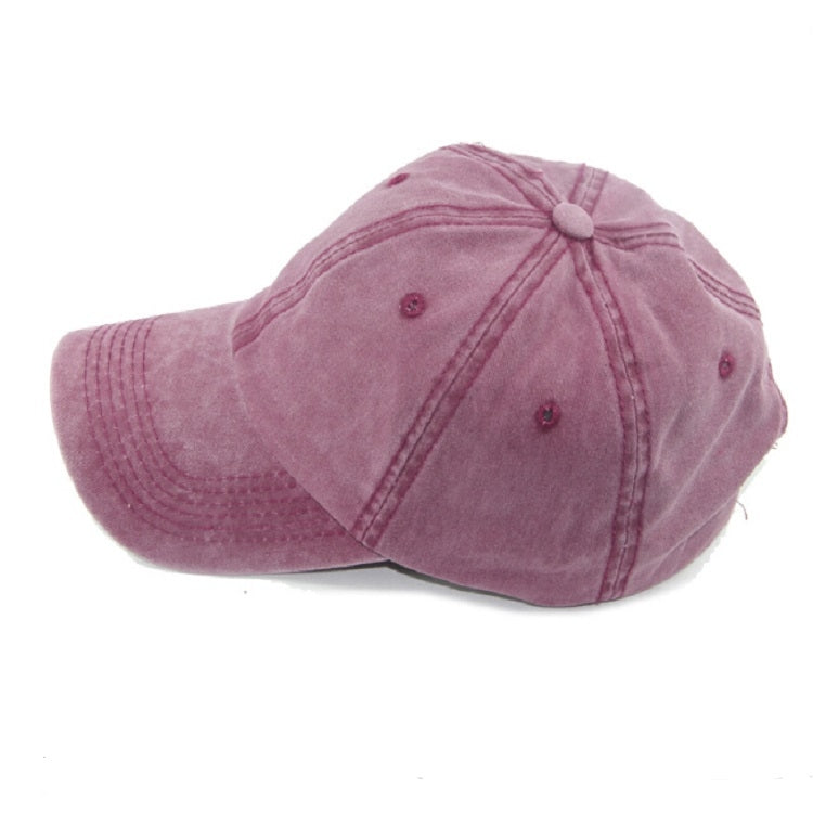 Pink washed cotton baseball cap, side view with stitched seams and small eyelets