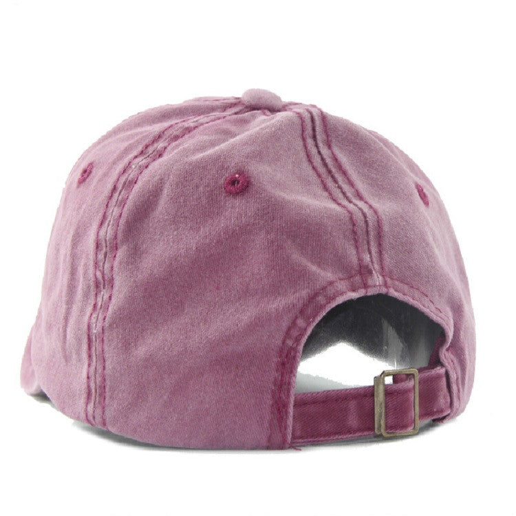 Pink washed cotton baseball cap with adjustable strap and buckle at the back