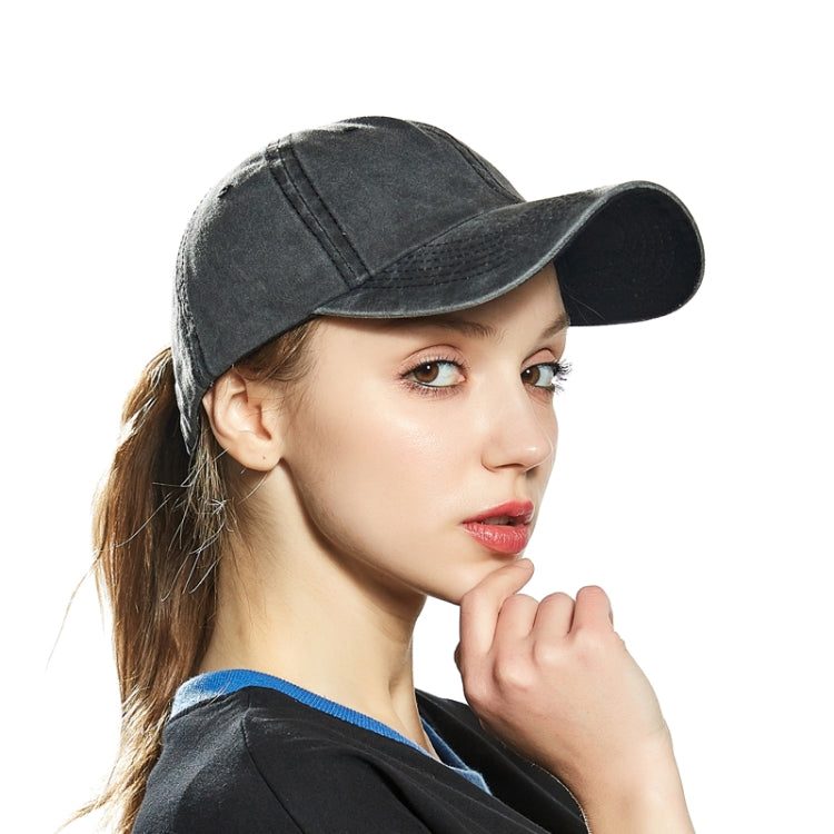 Dark gray washed cotton baseball cap worn by woman, close-up front