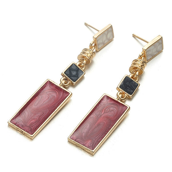 Gold-tone geometric drop earrings with red rectangular marbled dangles and black square accents