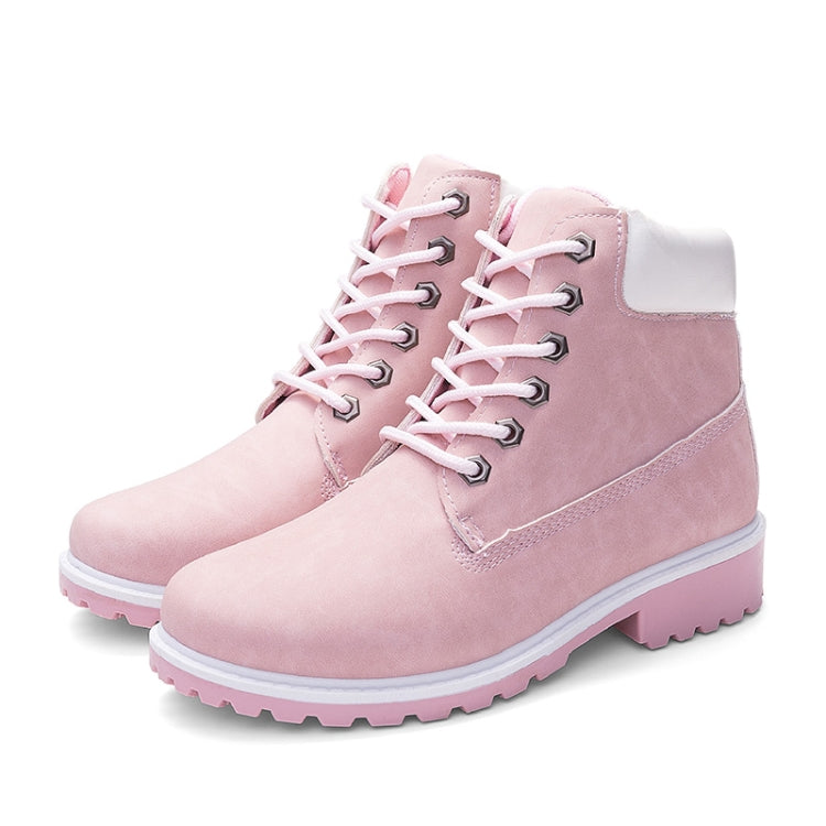 Pair of pink lace-up warm ankle boots with padded collar and rugged tread sole
