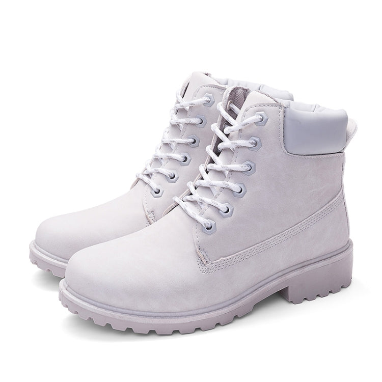 White lace-up warm boots with padded collar, side tab, and thick treaded sole