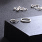 Silver-tone rings on display: braided band, beaded edge band, and leafy design ring