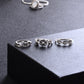 Silver-tone ring set on display featuring dark cluster, textured top, and patterned bands