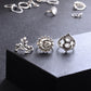 Silver-tone rings on display: sun face, filigree waterdrop, and circular ornate motif