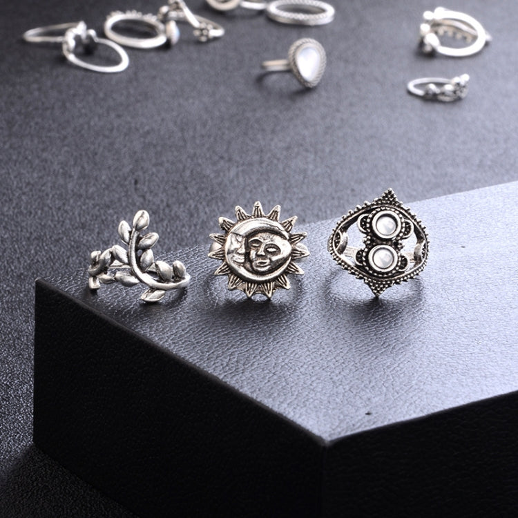 Silver-tone rings on display: sun face, filigree waterdrop, and circular ornate motif