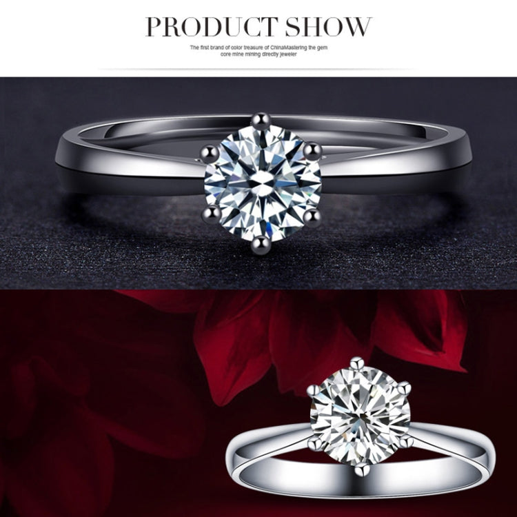 Silver-tone wedding ring with large round clear CZ center and small ball accents