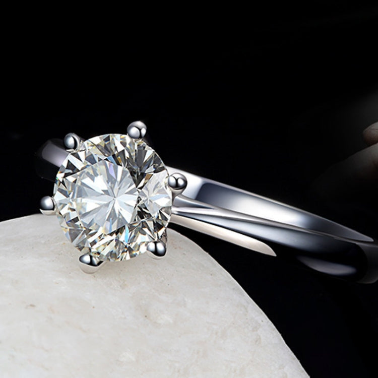 Silver-tone ring with large round CZ solitaire and six small ball prongs, glossy finish