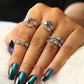 Adjustable star and moon rings in silver tone with sparkling stones, worn on hand