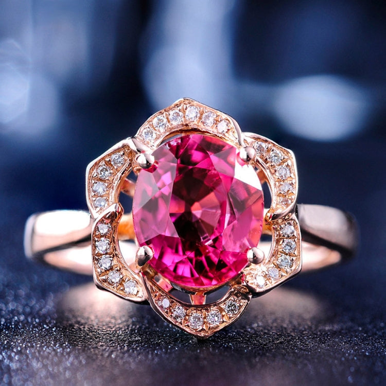 Rose gold flower halo ring with large pink gemstone and clear stone detailing
