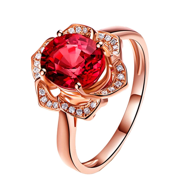 Rose gold flower ring with red round center stone and clear accent stones
