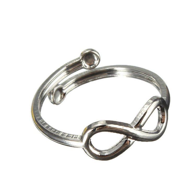 Silver metal toe ring with infinity charm and curved band, close-up