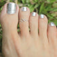 Silver toe ring with infinity charm on toes, smooth rounded band