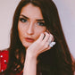 Woman wearing an adjustable butterfly crystal ring on her finger