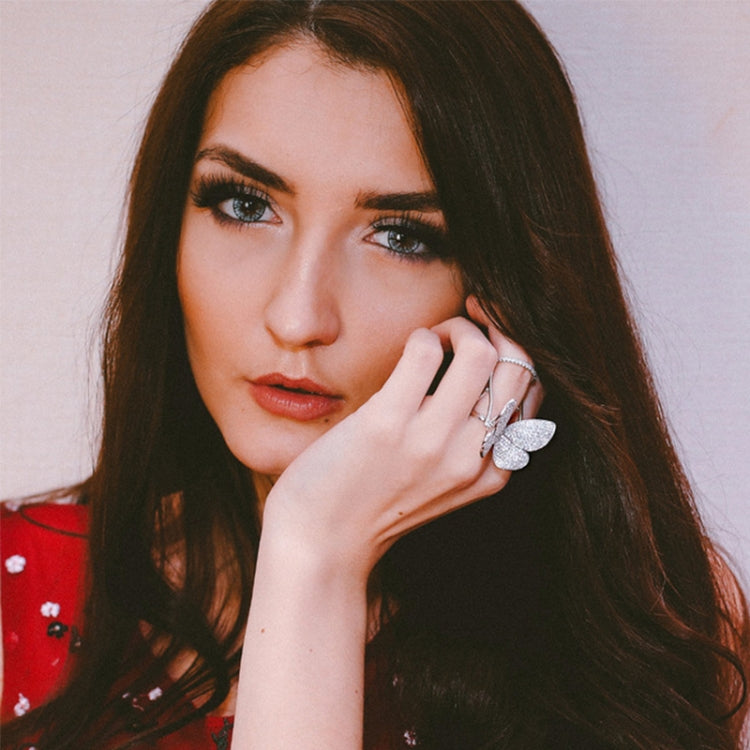 Woman wearing an adjustable butterfly crystal ring on her finger