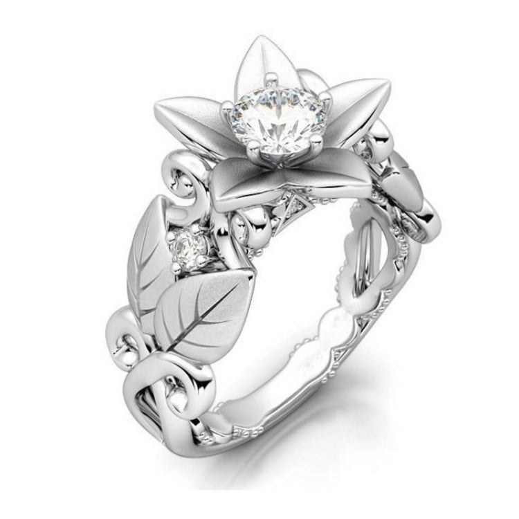 Silver flower wedding ring with central clear stone and sparkling diamond accents