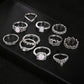 Silver-tone ring set with oval opal-style stones and decorative bands, assorted views