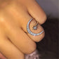 Silver-tone crescent moon crystal ring with star accent, close-up view on finger