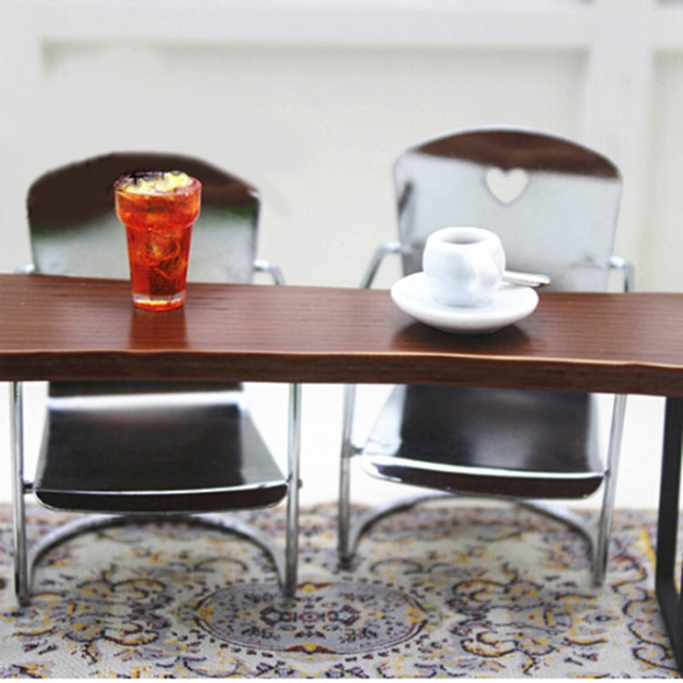 Miniature metal dollhouse chair pair with heart-cut backrests on patterned rug