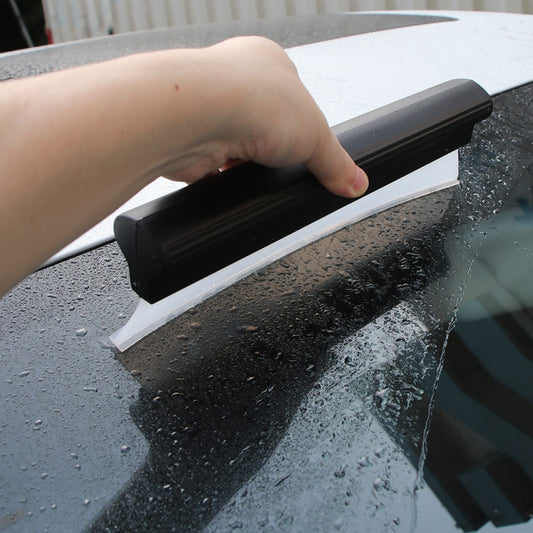 I-shaped water scraper with black handle and white squeegee blade in hand