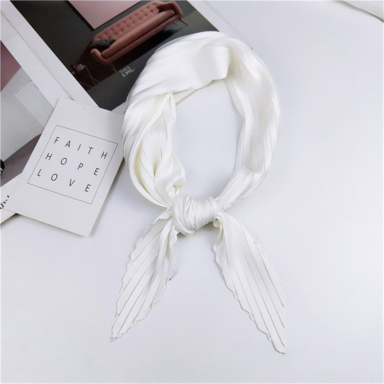 White pleated square silk scarf, looped and tied with vertical pinstripe long ends