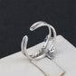 Platinum butterfly diamond opening ring, side view of curved stacked bands