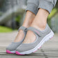 Gray mesh slip-on flat sneakers on foot with pink outsole