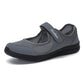 Gray mesh slip-on flat sneakers with padded collar and black rubber sole