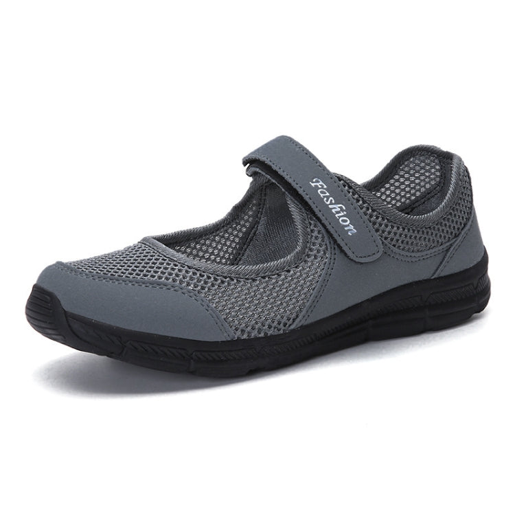 Gray mesh slip-on flat sneakers with padded collar and black rubber sole