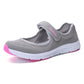 Light gray mesh slip-on flat sneakers with pink sole trim and cushioned collar