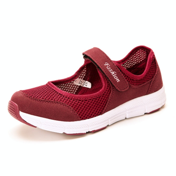 Red mesh slip-on flat sneakers with white sole and padded collar