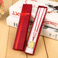 Red rectangular necklace gift box with ribbon bow, open with necklace insert